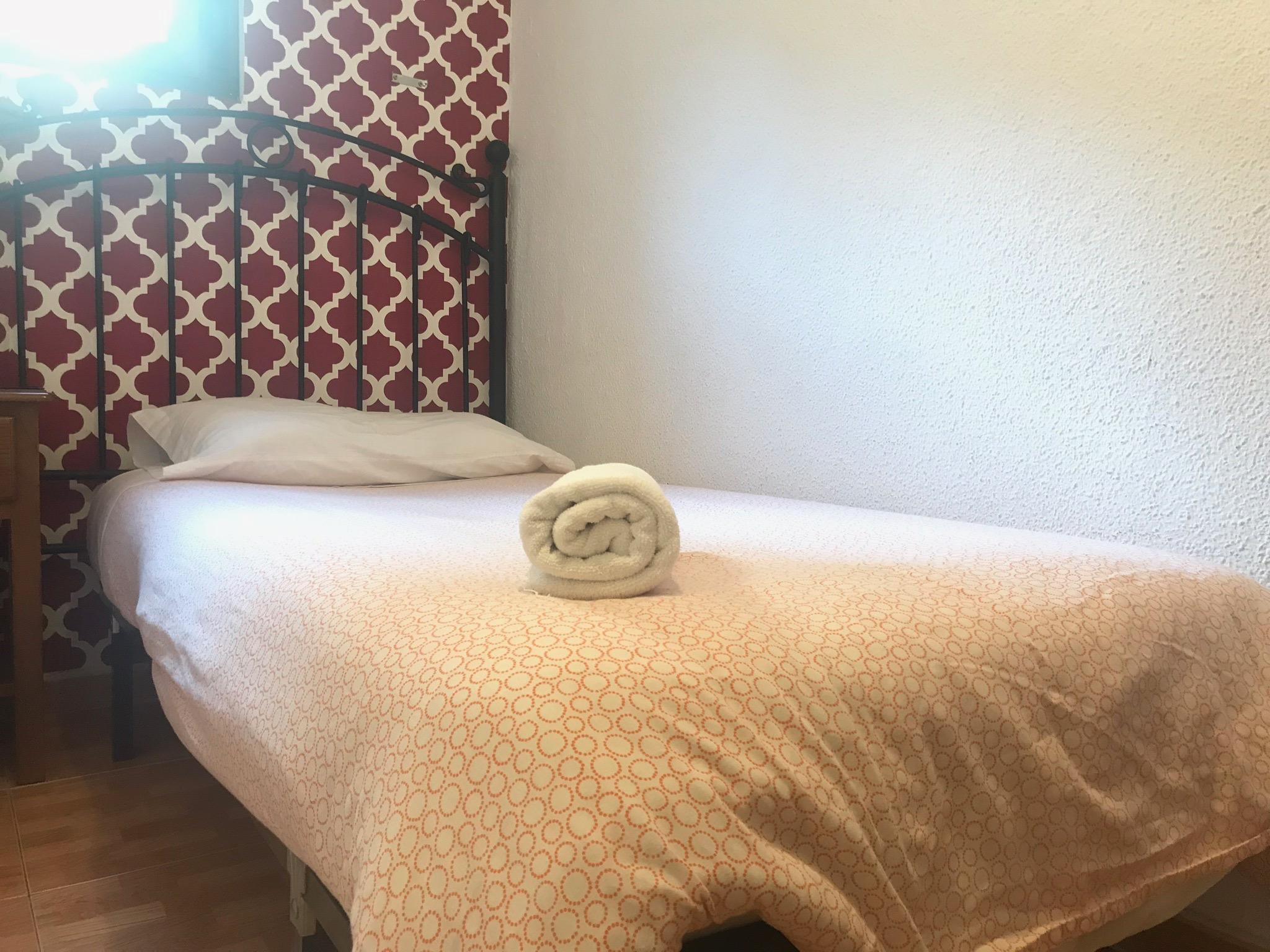 Hostal Los Perales Madrid Exterior photo A bed with a rolled towel